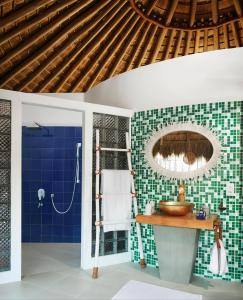 a bathroom with a shower, sink, and toilet at Jetwing Surf in Arugam Bay