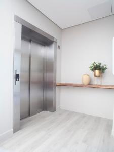 an open elevator door in a room with white walls at Zest Boutique Hotel by The Living Journey Collection in Cape Town