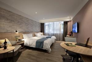 Cama o camas de una habitación en Hanyong Hotel -Shenzhen International Convention&Exhibition Fuyong Branch