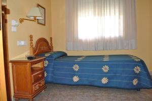 Postel nebo postele na pokoji v ubytování Hostal Rey Teodomiro