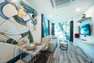 a living room with a painting on the wall at Su Casa Hanoi Old Quarter in Hanoi