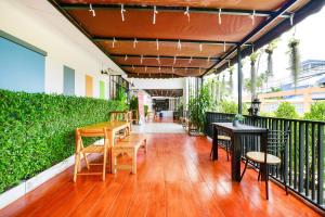 a patio with tables and chairs on a balcony at Pattaya Bed Boutique SHA in Nong Prue