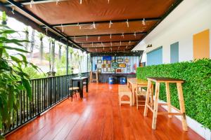 a room with a table and chairs on a balcony at Pattaya Bed Boutique SHA in Nong Prue