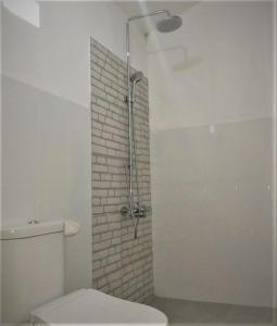 a bathroom with a shower and a toilet in it at Balakosa Gili Meno Bungalow in Gili Meno