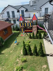 a playground in the backyard of a house at Pensjonat SYRENA in Krynica Morska