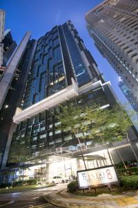a tall building with a sign in front of it at Binjai 8 KLCC by PSM Luxury Suites in Kuala Lumpur