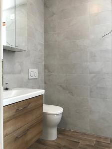 a bathroom with a toilet and a sink at Apartments Simoneta in Malinska