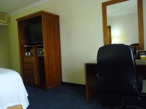a hotel room with a desk and a chair and a television at Holiday Inn Express Oaxaca - Centro Historico by IHG in Oaxaca City
