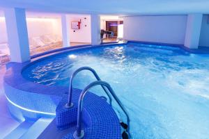 a large swimming pool in a hotel room at R2 Bahia Cala Ratjada - Adults Only in Cala Ratjada