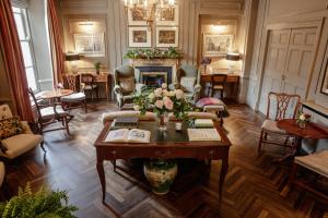 a living room with a table and a fireplace at Pembroke Townhouse in Dublin