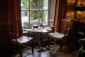 a table with a cake on it in front of a window at Pembroke Townhouse in Dublin