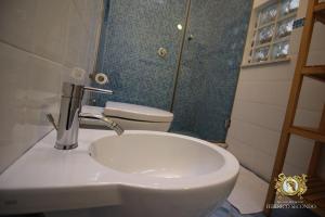 a white sink sitting next to a bathroom mirror at Bed And Breakfast Federico Secondo in Palermo