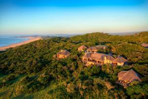an aerial view of a house on a hill next to the ocean at Oceana Beach and Wildlife Reserve in Port Alfred