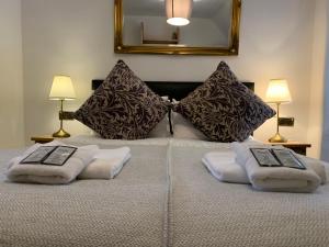 a bed with two pillows on top of it at Royal Mile Balconies by the Castle in Edinburgh