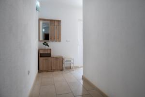 a hallway with a mirror and a cabinet in a room at Apartments Lavanda in Neum +26 photos