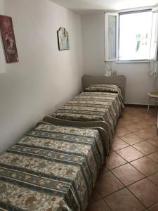 A bed or beds in a room at Tana Dell'Orso
