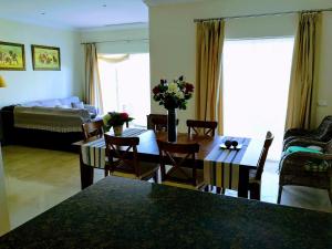 a living room with a table and chairs and a couch at FAIRWAY GARDENS in Arcos de la Frontera