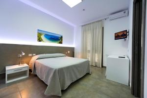 a bedroom with a large bed in a room at Le Camere del Crimiso in Castellammare del Golfo