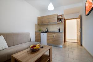 a living room with a couch and a bowl of fruit on a table at Apartments Lavanda in Neum