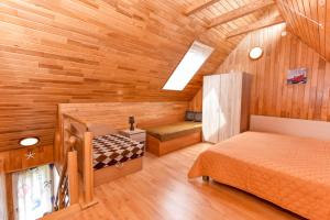 a room with two beds in a wooden cabin at Kotedžiukai Šventojoje in Šventoji