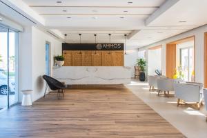 a lobby of an office with chairs and a table at Enorme Ammos Beach Resort in Malia