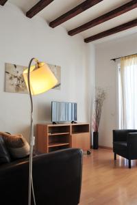 a living room with a couch and a lamp at Apartamentos Bejar in Barcelona