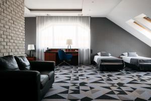 a hotel room with two beds and a couch at Hotel Apis in Krakow +101 photos
