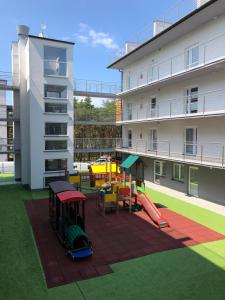 a playground in the courtyard of a building at apartament Wakacje w Rowach in Rowy