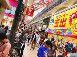 a crowd of people walking through a shopping mall at Ryokoheya Tenrokukan in Osaka