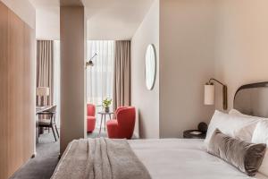 a hotel room with a bed and a desk at The Stratford Hotel London in London