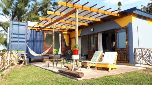 een huis met een hangmat ervoor bij Blue Space Beach house in Port Shepstone