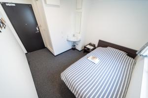 Postel nebo postele na pokoji v ubytování Port House Shibuya