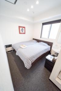 Postel nebo postele na pokoji v ubytování Port House Shibuya