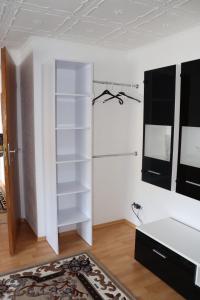 a room with a white book shelf and a closet at Ferien- und Monteurwohnung Julia in Mörlenbach