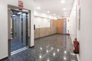 an empty hallway with a fire hydrant in a building at Apartamentos LA CATEDRAL 1ºA in Logroño