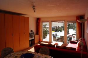 a living room with a couch and a large window at Apartments Krassnig in Krumpendorf am Wörthersee