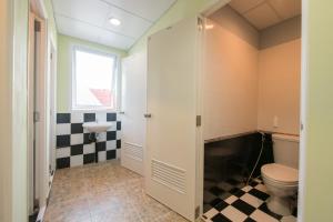 a bathroom with a toilet and a sink at Sindy's Hostel in Pattaya Central