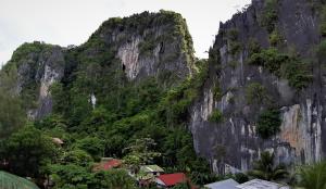 a mountain with a village in front of it at Laule'a Hostel in El Nido