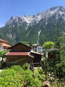 a village with a mountain in the background at Ferienhaus Lipp in Mittenwald