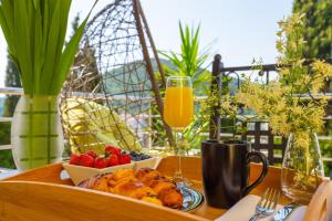 a table with a tray of food and a plate of fruit at Luxury Apartment Mr. Perfect in Dubrovnik