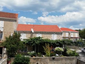 a row of houses with red roofs at Village Apartment Skurić in Čilipi