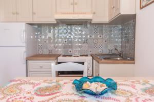 a kitchen with a table with a towel on it at Albatross Holiday Apartments in Agios Sostis