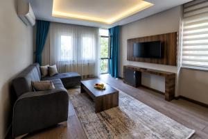 a living room with a couch and a tv at Ferah Suites Hotel in Trabzon