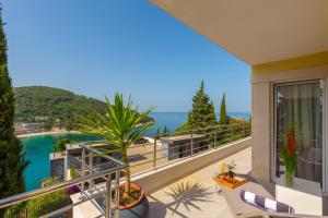 a balcony of a house with a view of the ocean at Luxury Apartment Mr. Perfect in Dubrovnik