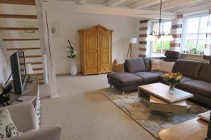 a living room with a couch and a tv at Ferienwohnung Abendrot in Bodenmais