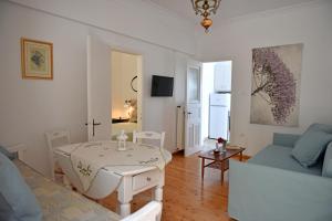 a living room with a table and a couch at MARE VISTA in Evdilos