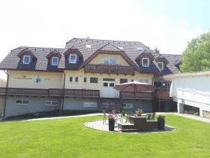 a large building with a lawn in front of it at A1 Štart in Starý Smokovec