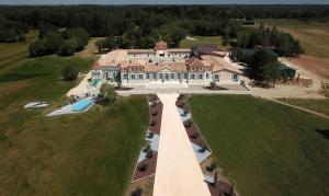 an aerial view of a large house with a pool at Chateau Prieure Marquet in Saint-Martin-du-Bois