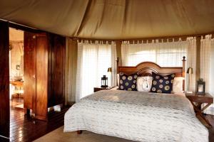 a bedroom with a large bed with a canopy at Thanda Safari in Hluhluwe