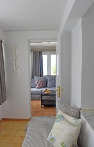 a living room with a couch and a window at MARE VISTA in Evdilos